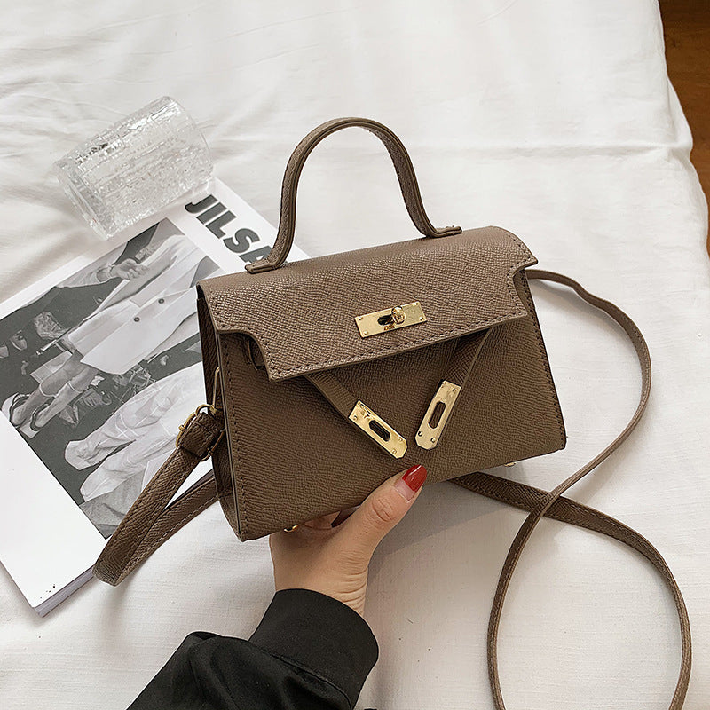 Bolsos de mujer 2025 primavera/otoño Nueva moda de botón Bolsos de mujer Bolsos de mujer de un solo hombro en relieve de moda Bolso bandolera cruzado de moda
