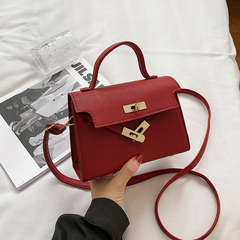 Bolsos de mujer 2025 primavera/otoño Nueva moda de botón Bolsos de mujer Bolsos de mujer de un solo hombro en relieve de moda Bolso bandolera cruzado de moda