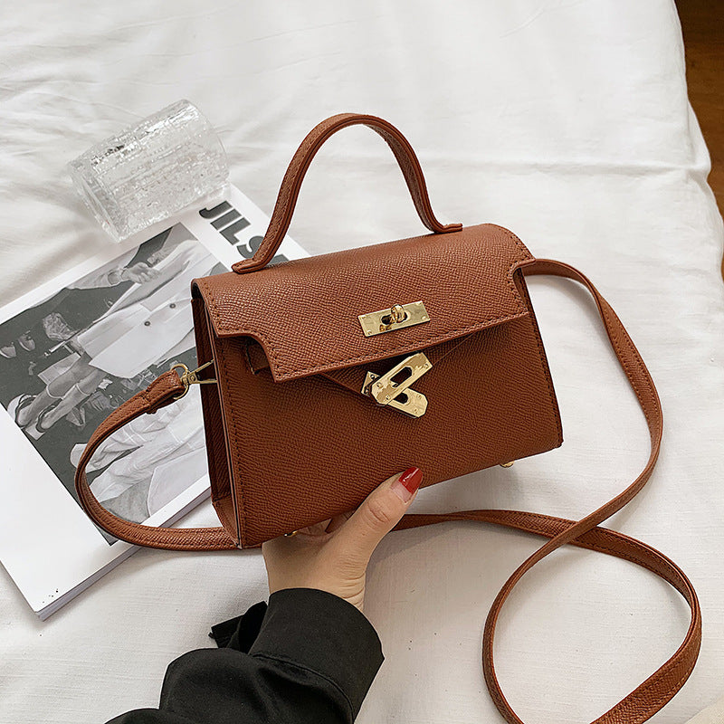 Bolsos de mujer 2025 primavera/otoño Nueva moda de botón Bolsos de mujer Bolsos de mujer de un solo hombro en relieve de moda Bolso bandolera cruzado de moda