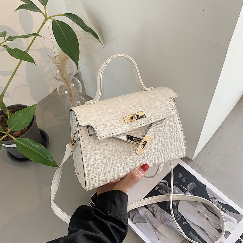 Bolsos de mujer 2025 primavera/otoño Nueva moda de botón Bolsos de mujer Bolsos de mujer de un solo hombro en relieve de moda Bolso bandolera cruzado de moda