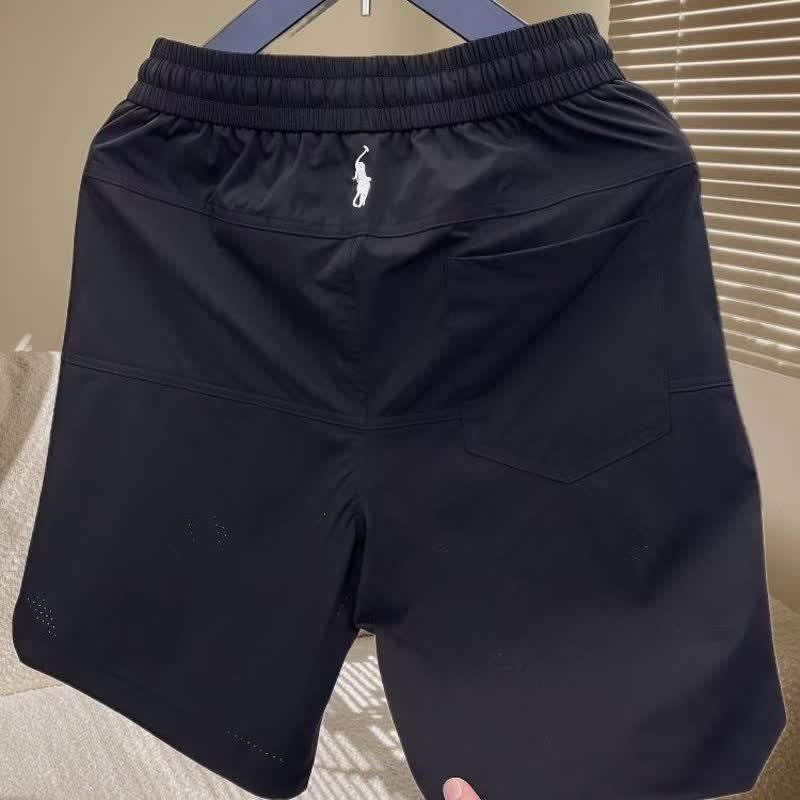 Nuevos pantalones cortos casuales transpirables perforados con láser para hombre en verano, pantalones de seda de hielo rápido y sueltos y sueltos de cinco puntos