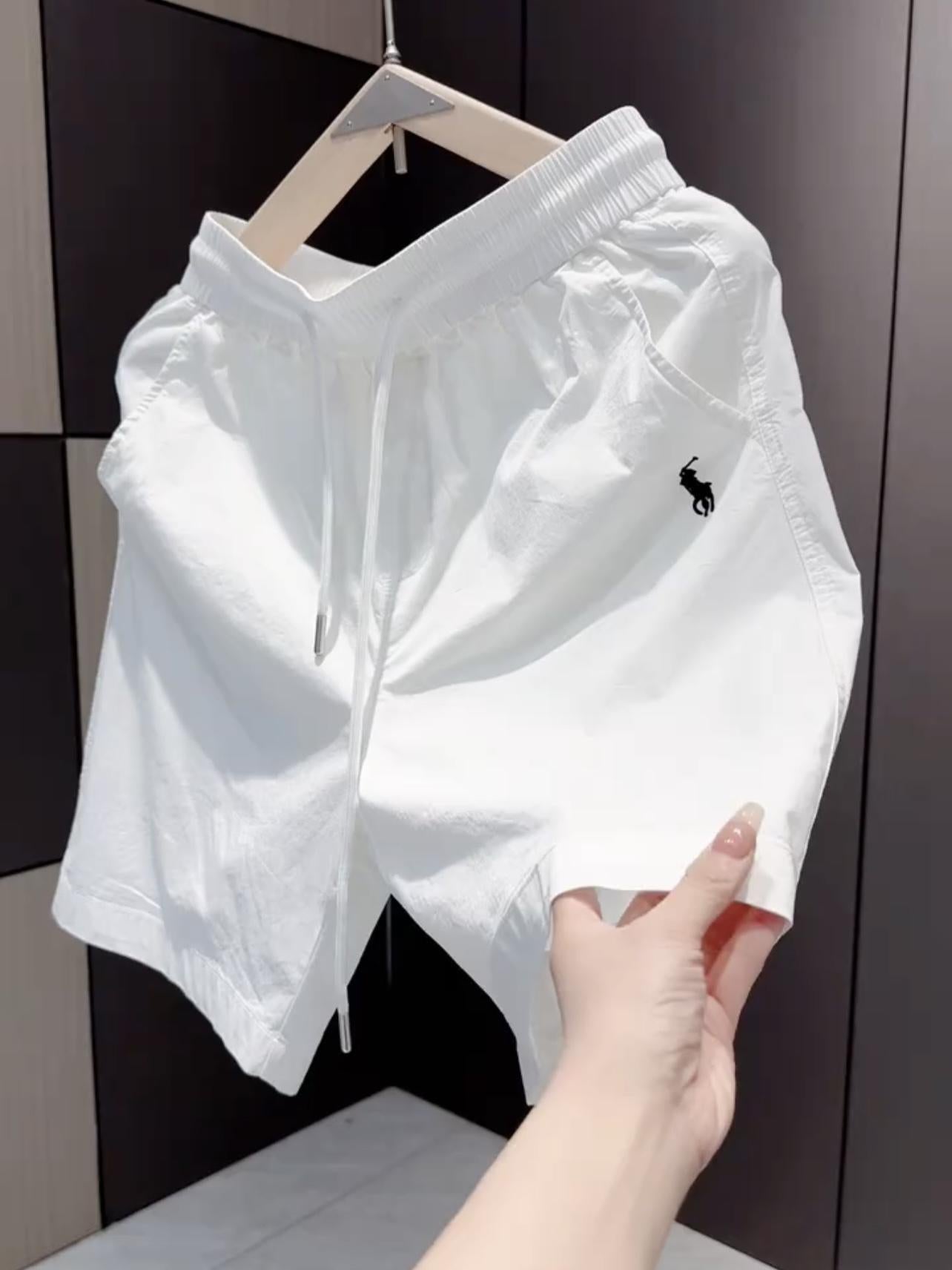 Nuevos pantalones cortos casuales masculinos de verano 2025, pantalones deportivos de playa de secado rápido y pierna recta holgados, pantalones versátiles americanos de cinco puntos