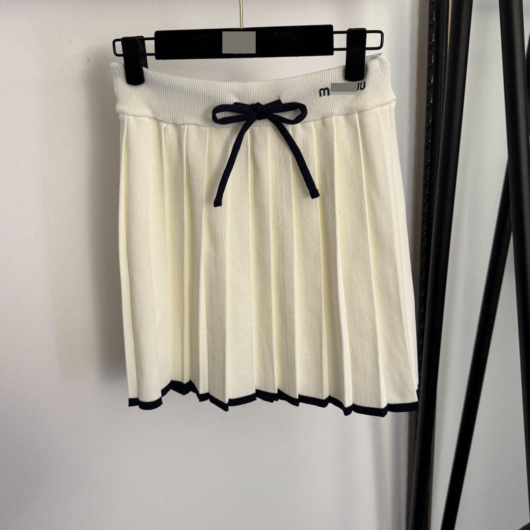 Nanyou top de punto de punta con lazo de alta gama con letras bordadas en solapa y conjunto de falda corta plisada