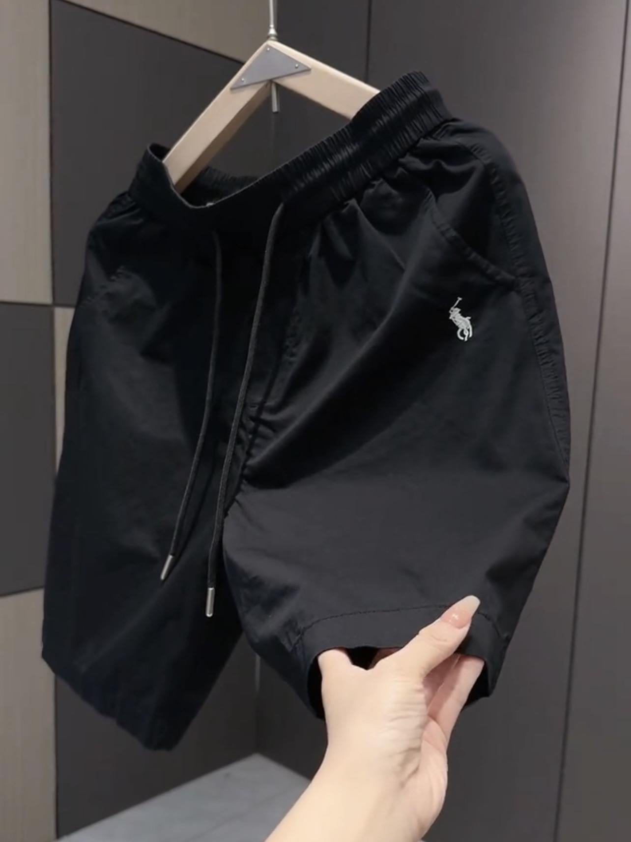 Nuevos pantalones cortos casuales masculinos de verano 2025, pantalones deportivos de playa de secado rápido y pierna recta holgados, pantalones versátiles americanos de cinco puntos