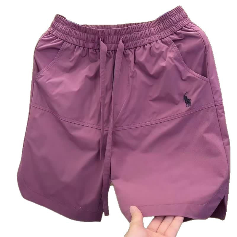 Nuevos pantalones cortos casuales transpirables perforados con láser para hombre en verano, pantalones de seda de hielo rápido y sueltos y sueltos de cinco puntos