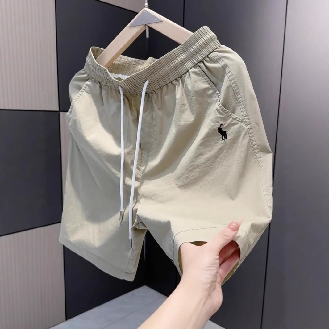 Nuevos pantalones cortos casuales masculinos de verano 2025, pantalones deportivos de playa de secado rápido y pierna recta holgados, pantalones versátiles americanos de cinco puntos