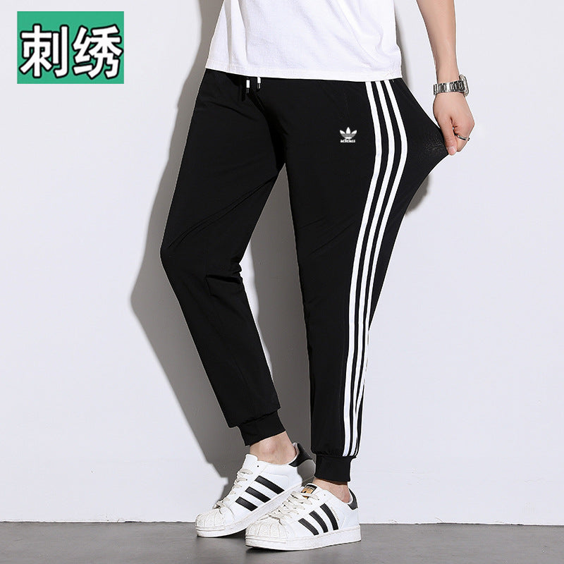Pantalones deportivos de seda hielo de tres rayas para hombres y mujeres, pantalones finos casuales de verano, pantalones transpirables de alta elasticidad y secado rápido para hombres